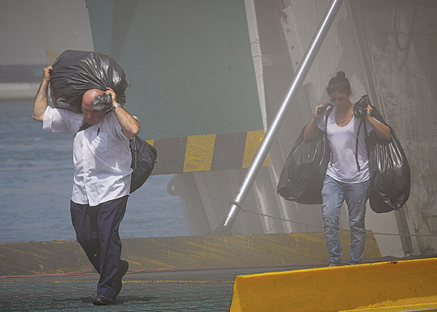 Επιβάτες παίρνουν τα πράγματά τους σε μαύρες σακούλες