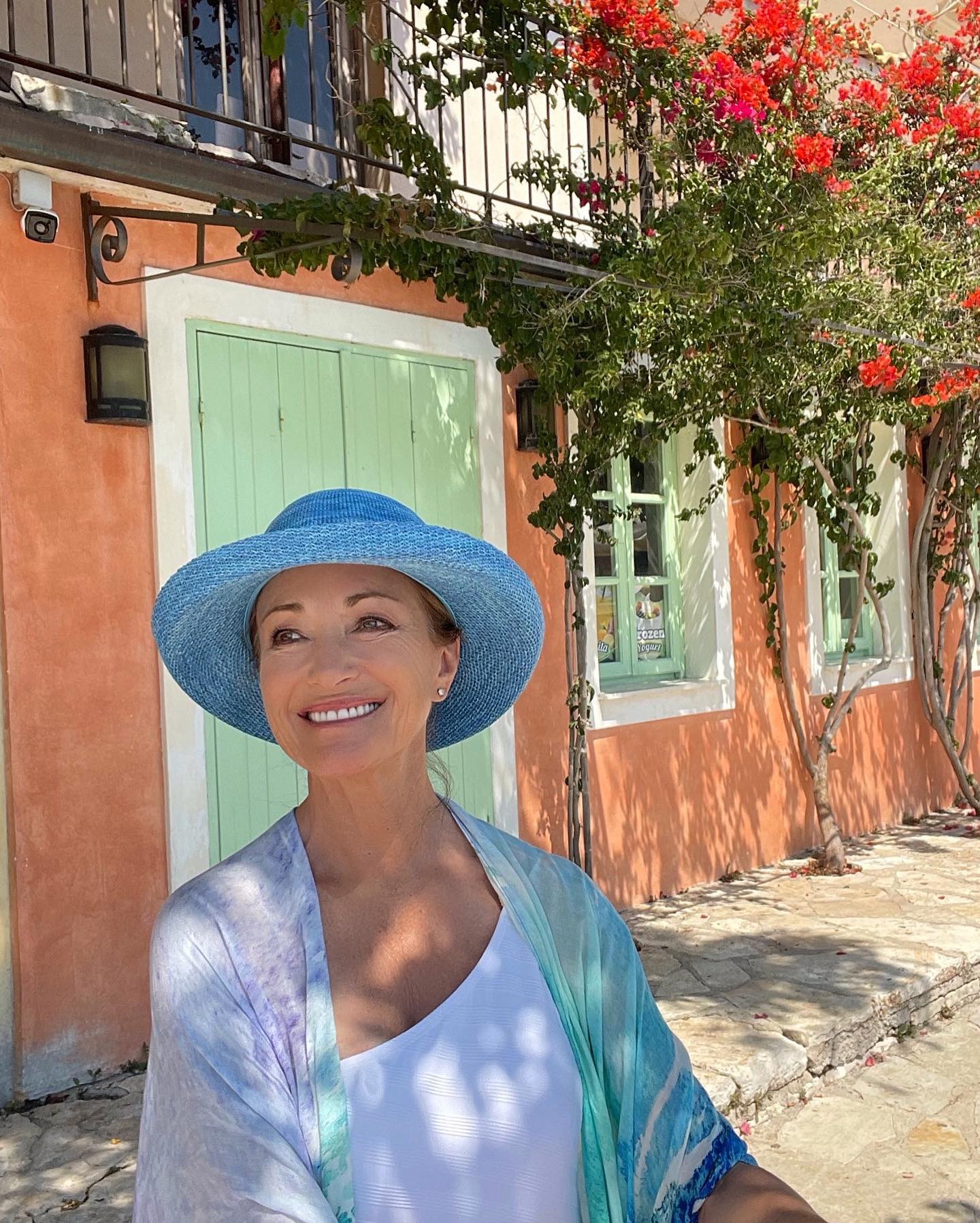 Photo by Jane Seymour OBE in Greece. May be an image of 1 person hat parasol headscarf sarong and