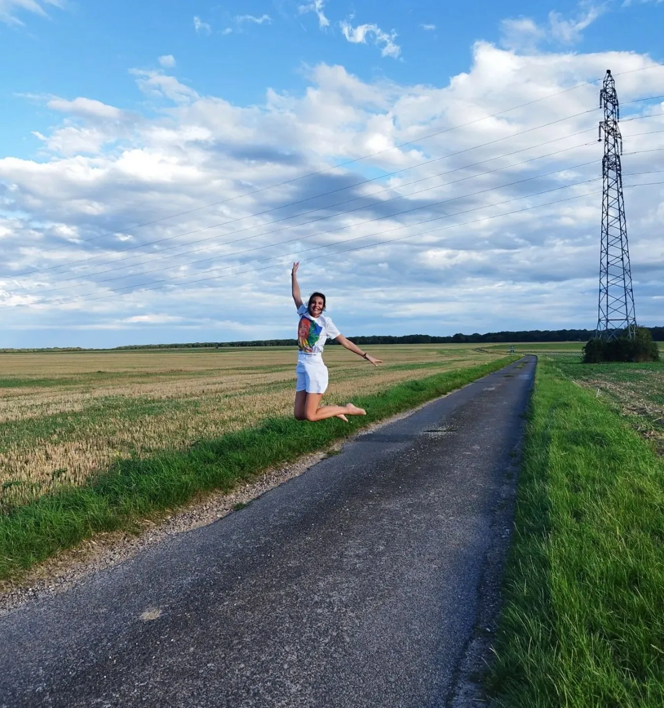 Photo by Anastasia Padousi Official on August 22 2023. May be an image of 1 person silo windmill road grass and telephone pole jpg
