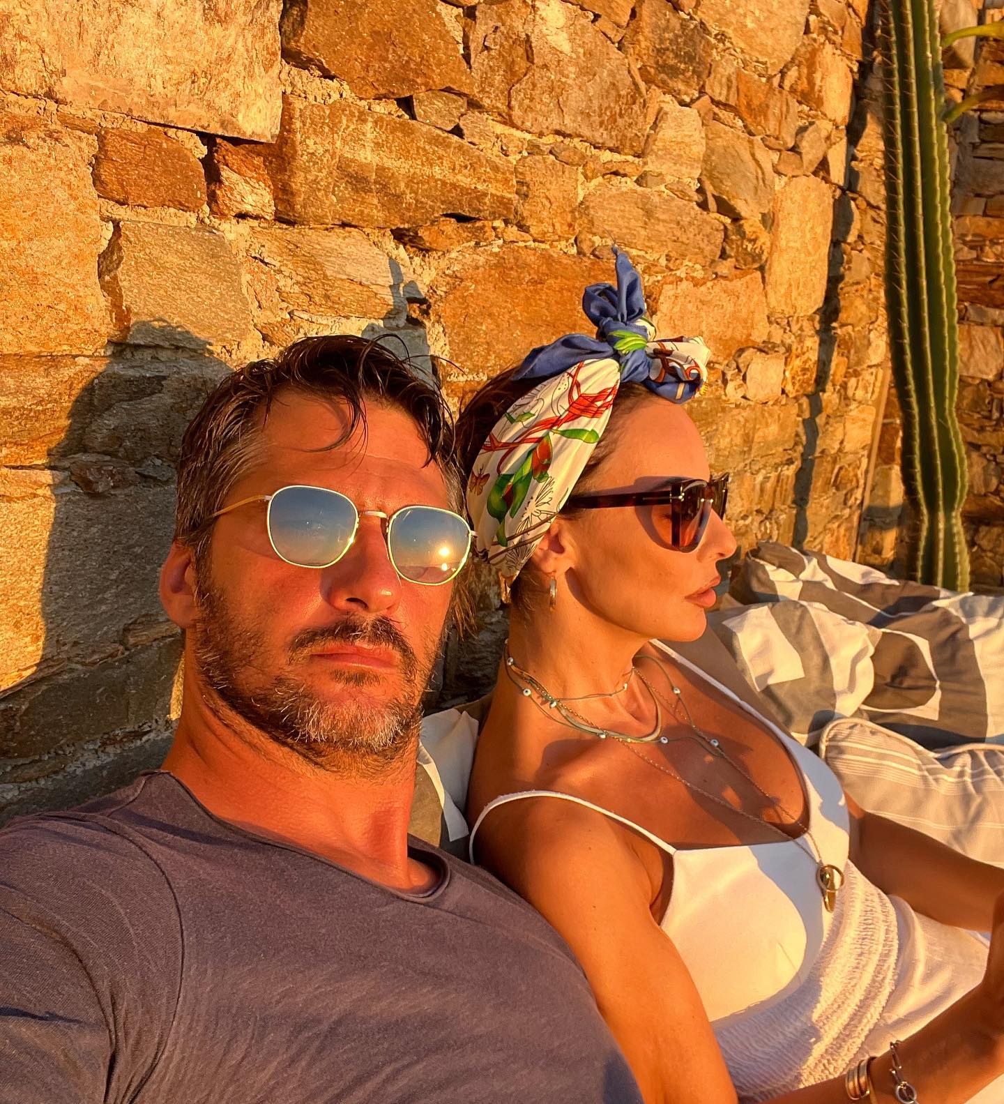 Photo shared by BETTY ΜΑGGIRA on August 17 2023 tagging @mazis dimitris. May be an image of 2 people beard eyewear deck chair headscarf sarong and outdoors