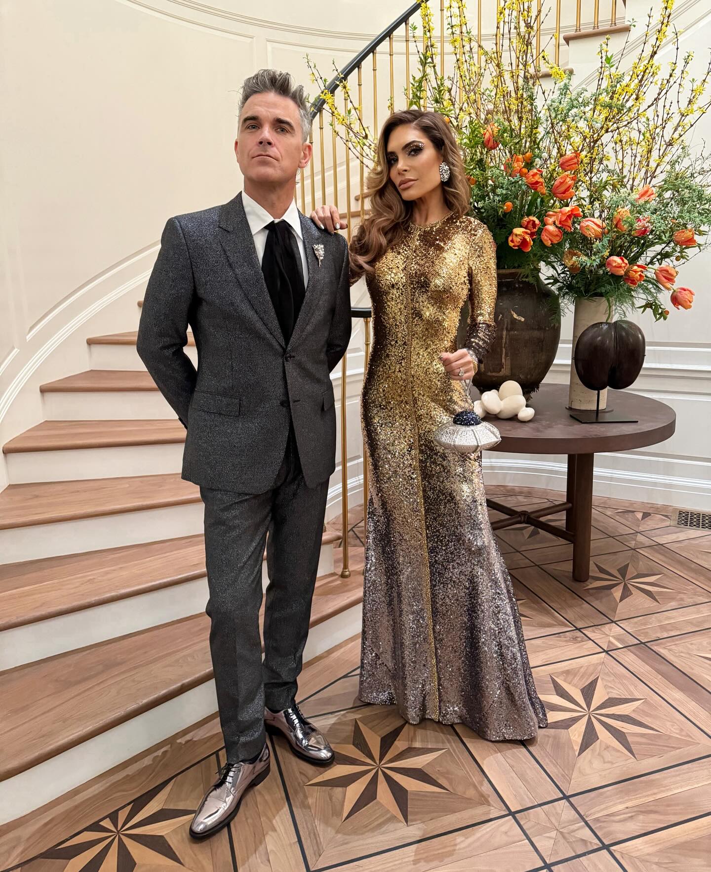 Photo shared by Ayda Field Williams on January 21 2024 tagging @reemacra @judithleiberny @hairbybradleyleake @robbiewilliams and @heyheyvictor. May be an image of 2 people suit dress gown d
