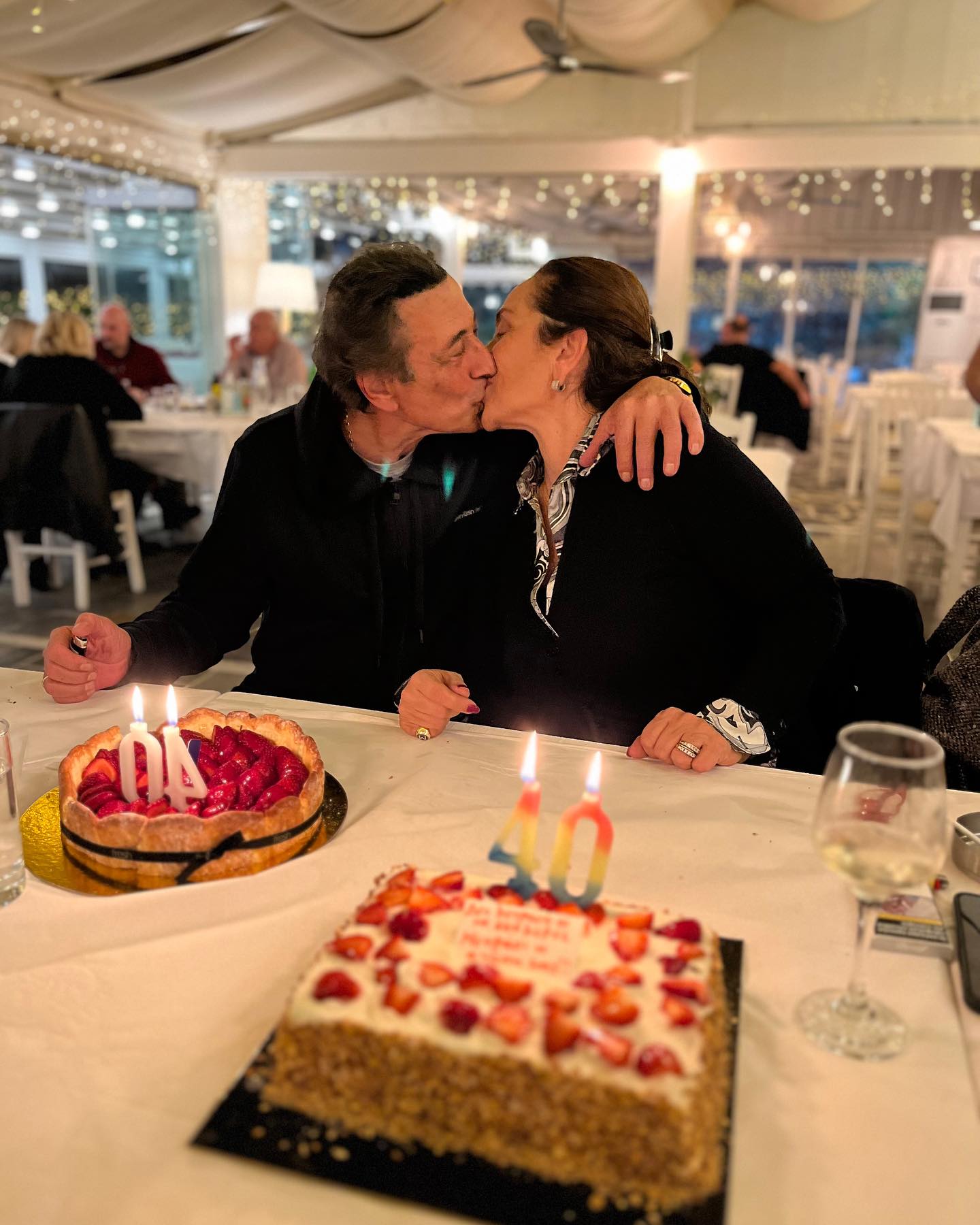 Photo by Antypas on December 11 2023. May be an image of 2 people people kissing cake and candle
