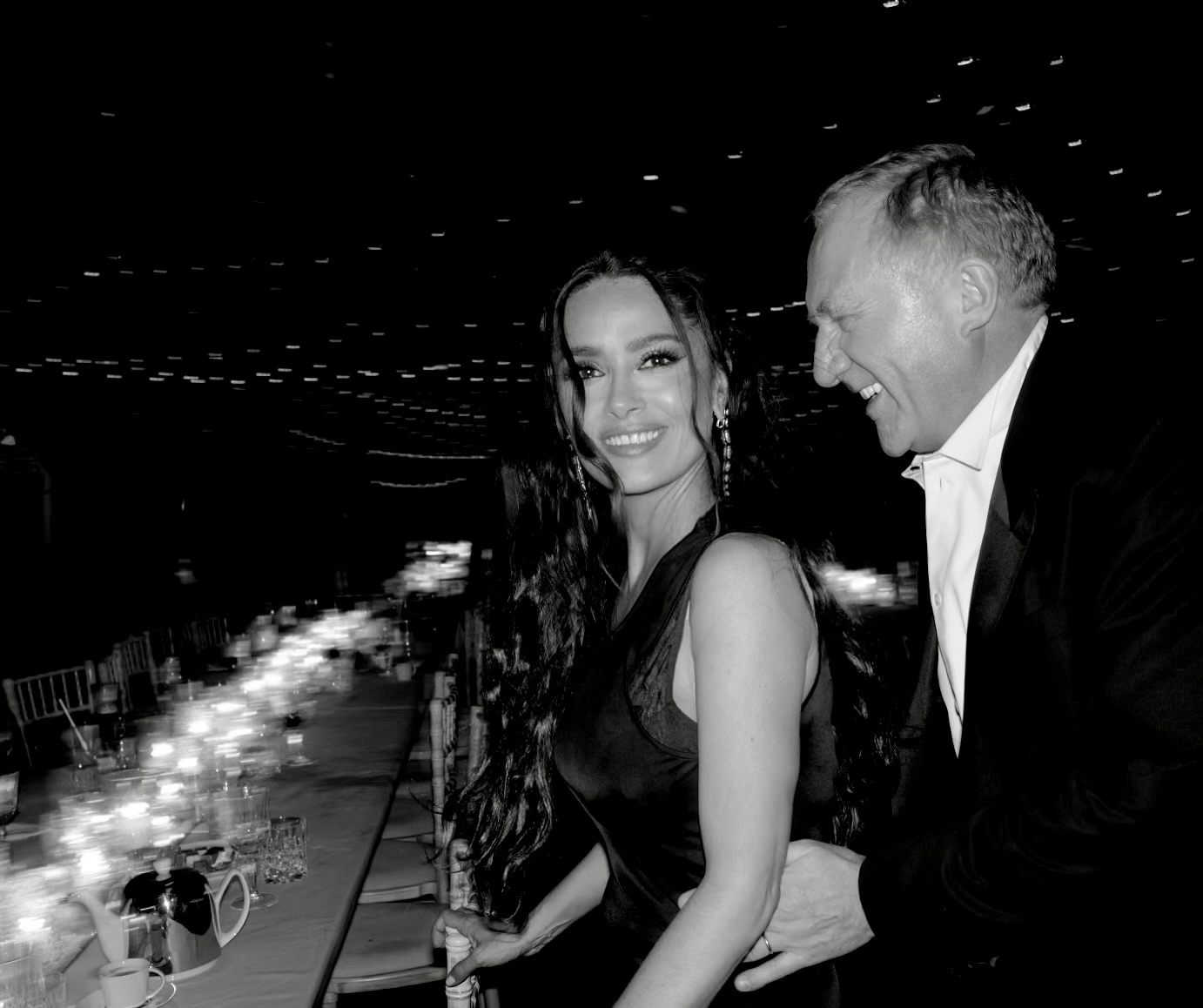 Photo by Salma Hayek Pinault on February 14 2024. May be a black and white image of 2 people makeup dinner jacket dress and